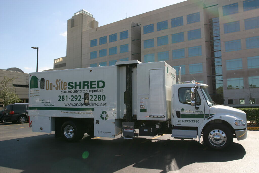 Shredding truck parked outside a building.