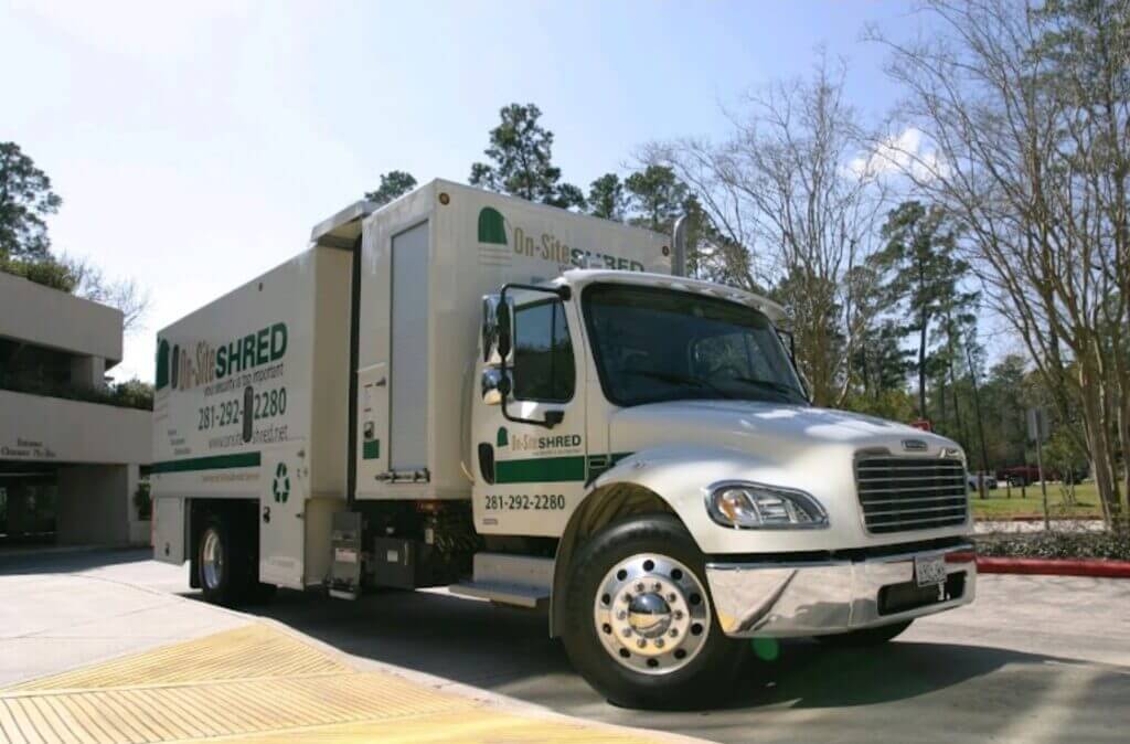 Shredding truck parked outside a building.