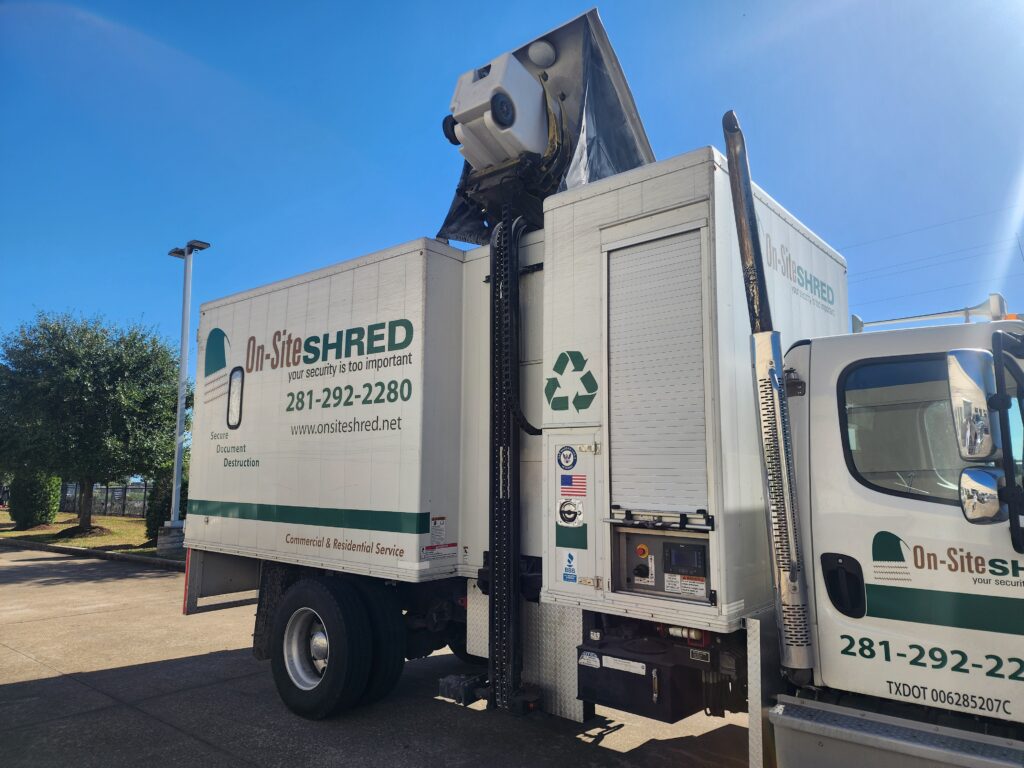 Shredding truck parked under clear blue sky.